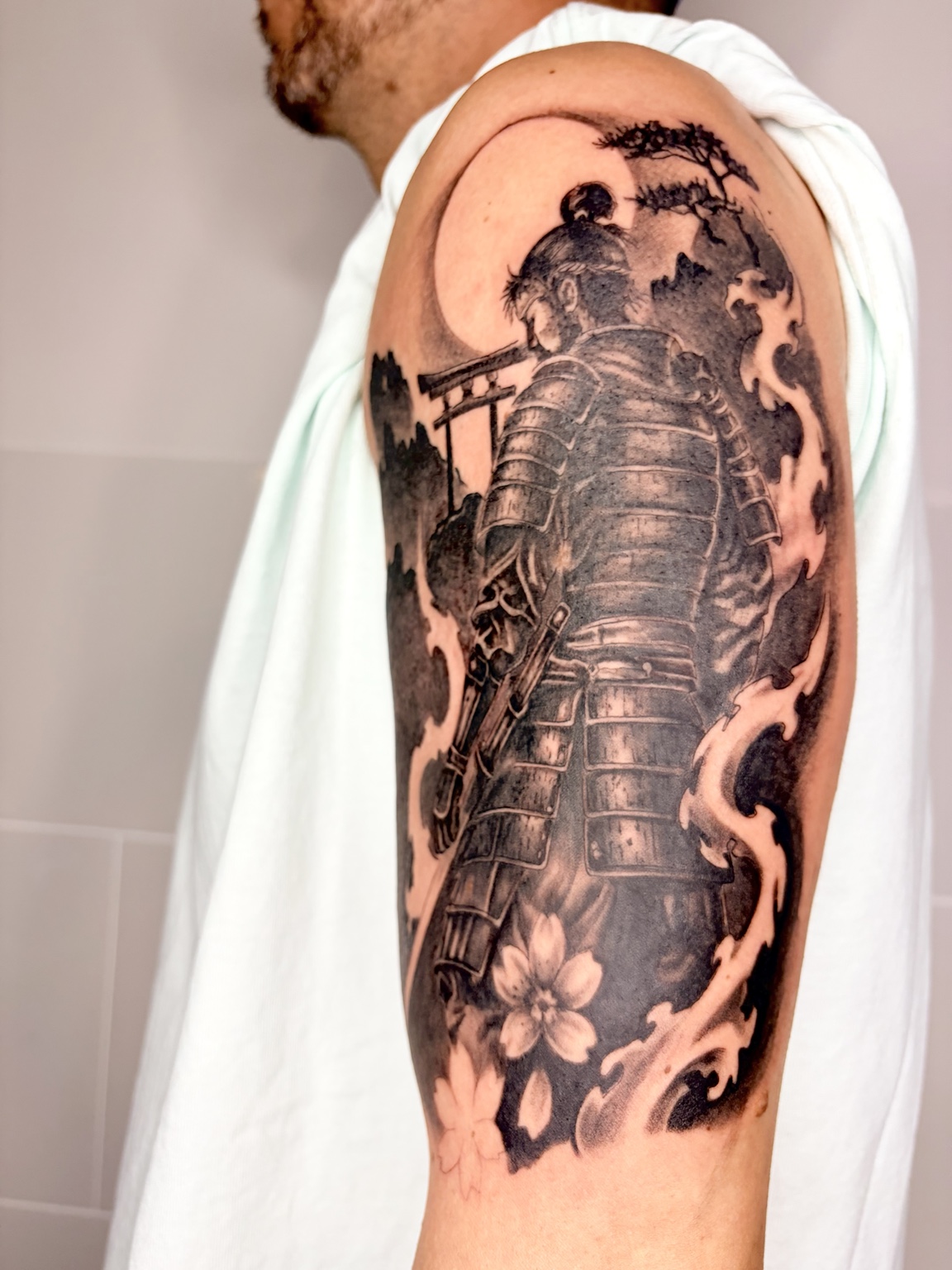 Samurai in Rüstung mit Kirschblüten und japanischen Motiven auf dem Oberarm