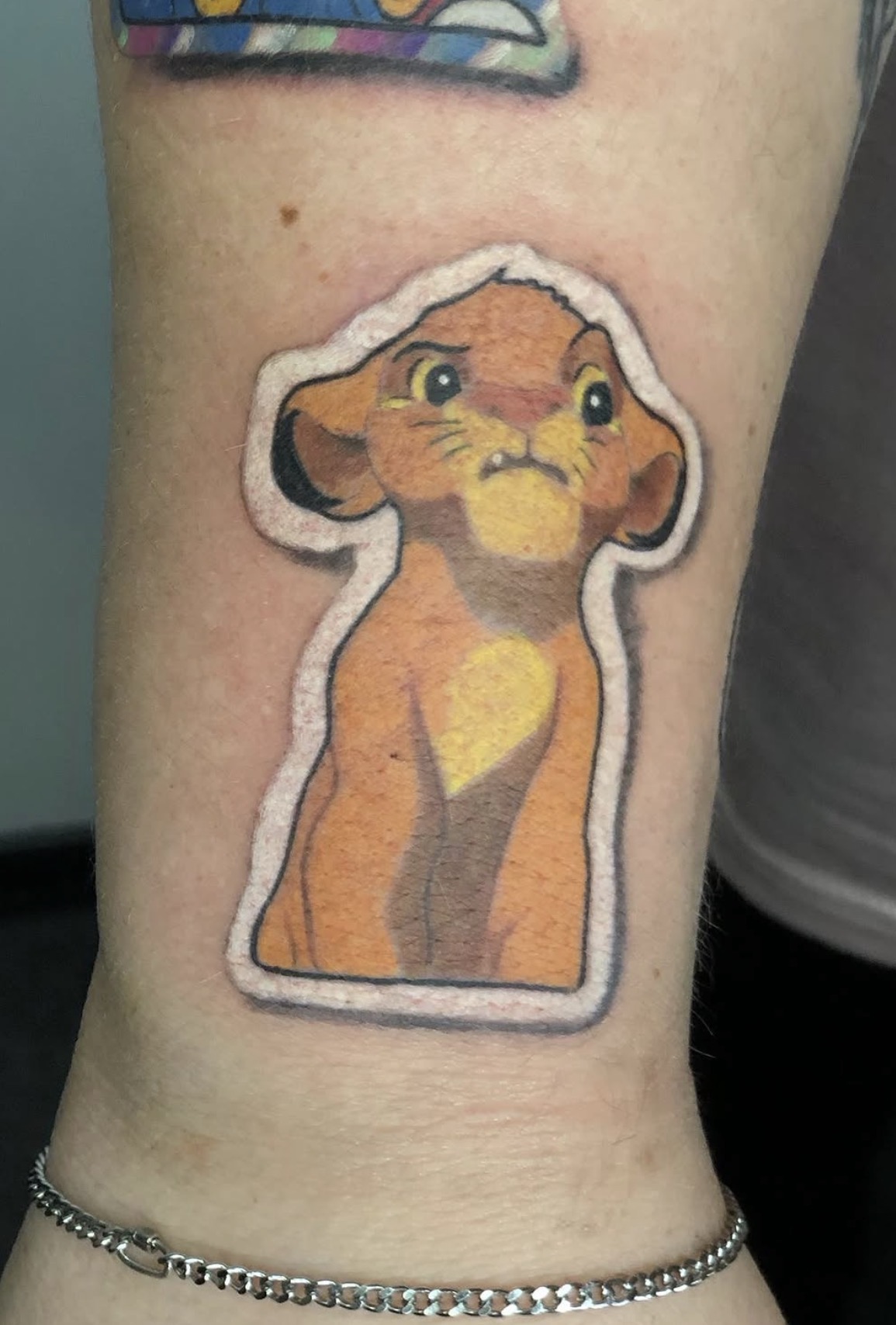 Simba als farbiges Tattoo mit weißem Rahmen